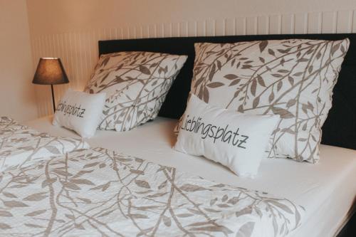 a bed with two pillows on top of it at Ferienwohnung Nr 3 in Hinrichsdorf