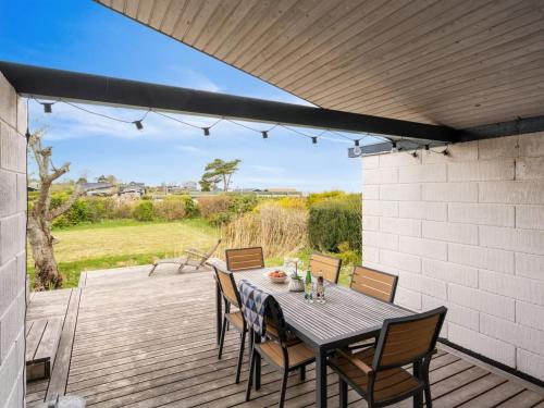 a patio with a table and chairs on a deck at Holiday Home Malena - 175m from the sea by Interhome in Allingåbro