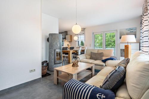 a living room with a couch and a table at Ferienvilla Kapitänshaus in Ostseebad Karlshagen