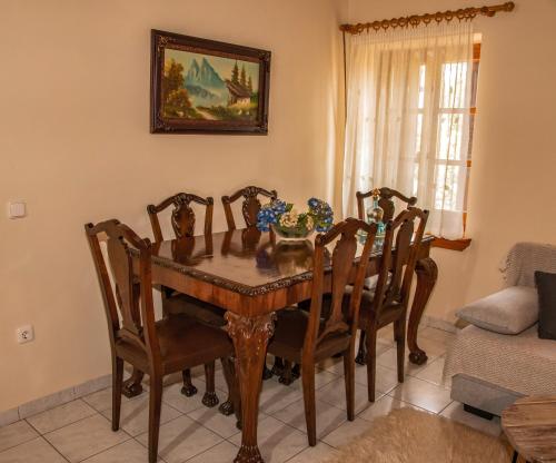a dining room with a wooden table and chairs at La Casa De Vacation in Lafkos