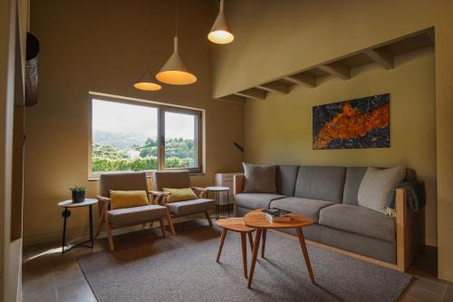 a living room with a couch and a table at Casa nas Caldeiras in Furnas