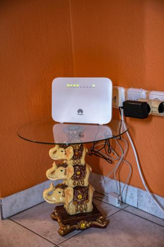 a glass table with a laptop on top of it at La Casa De Vacation in Lafkos