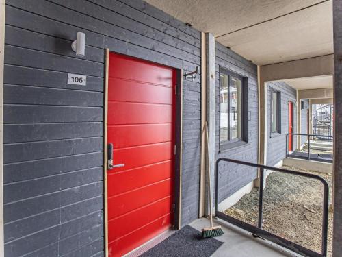 a red door on the side of a house at Holiday Home Levistar vi as- 6106 by Interhome in Levi
