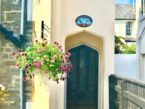 a door with a potted plant in front of it at Zeta Cottage in Ryde
