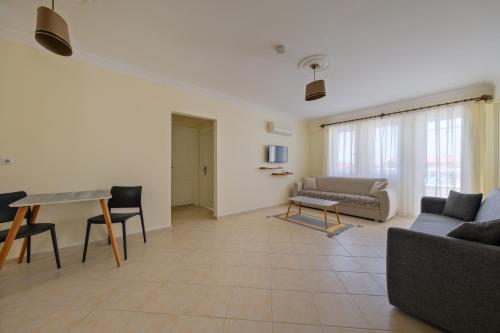 a living room with a couch and a table at Larimar Suite Hotel in Oludeniz