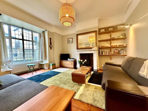 a living room with a couch and a fireplace at Zeta Cottage in Ryde