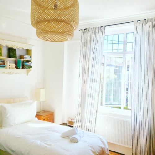 a bedroom with a bed and a large window at Zeta Cottage in Ryde