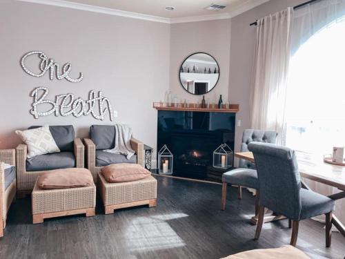 a living room with a couch and a fireplace at Majestic Inn and Spa in Anacortes