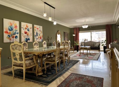 uma sala de jantar com mesa e cadeiras em Spacious, Luxurious 3-Bedroom Apartment in Nasr City for Families & Corporates no Cairo