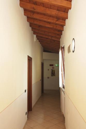 a hallway in a building with a wooden ceiling at Hotel Mantegna Stazione, MantegnaHotels in Mantova