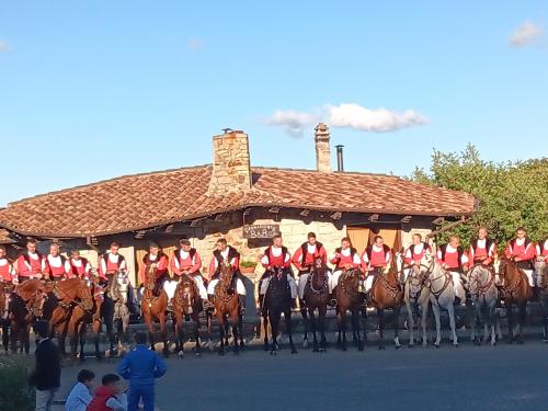a group of people on horses in front of a building at B&b Gennargentu in Fonni