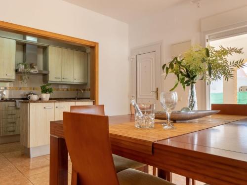a kitchen with a wooden table with glasses on it at Holiday Home Dani by Interhome in L'Eucaliptus