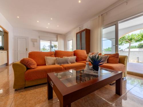 a living room with a couch and a coffee table at Holiday Home Dani by Interhome in L'Eucaliptus