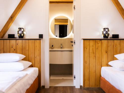 a bathroom with two beds and a sink at Holiday Home Vuk by Interhome in Kupjak