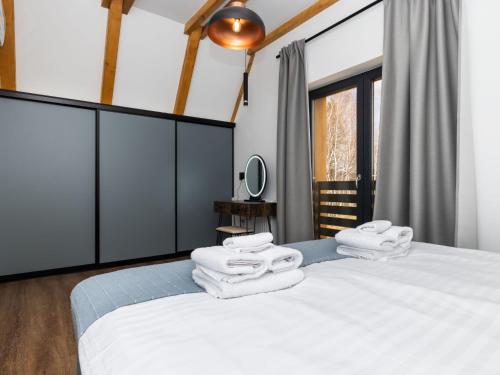 a bedroom with a bed with white towels on it at Holiday Home Vuk by Interhome in Kupjak