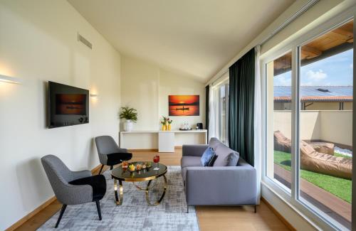 a living room with a couch and a table at Leonardo Hotel Lago di Garda - Wellness and Spa in Lazise