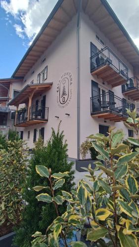 a white building with a sign on the side of it at Casa Montana in Commezzadura