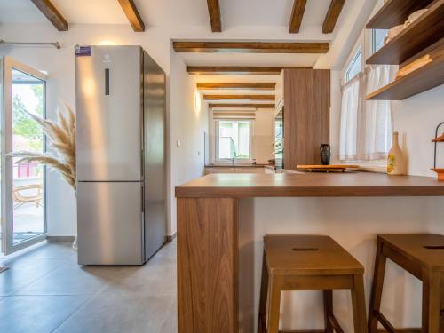 a kitchen with a stainless steel refrigerator and wooden counters at Apartment Artatore-2 by Interhome in Mali Lošinj