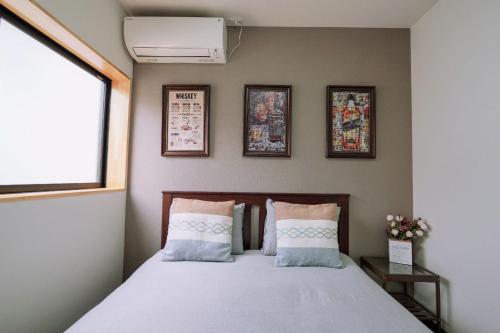 Postel nebo postele na pokoji v ubytování Tsubaki椿