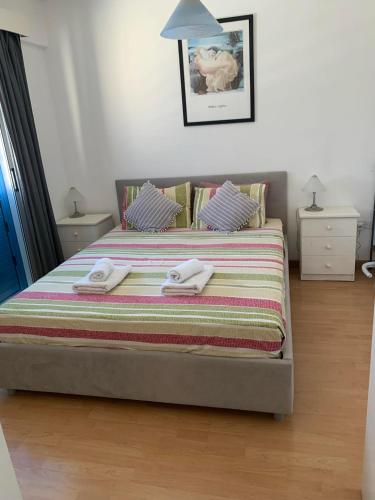 a bedroom with a bed with two towels on it at Gorgeous SeaView house in Pissouri