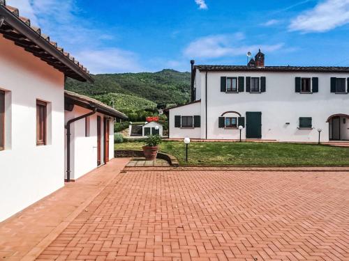 a brick driveway in front of a white house at Villa Il Sogno Di Pietro by Interhome in Fondaccio