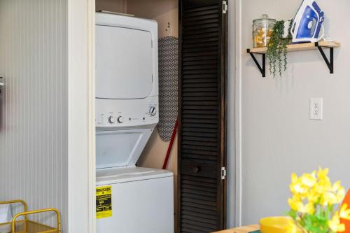 a kitchen with a refrigerator and a washer and dryer at Eclectic 3bd - Central Location in Pittsburgh - BBQ in Pittsburgh
