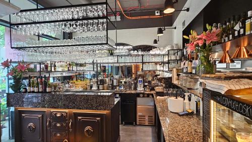 a bar with a counter with wine glasses at YOUR Apartment Unia Art Residence in Lublin