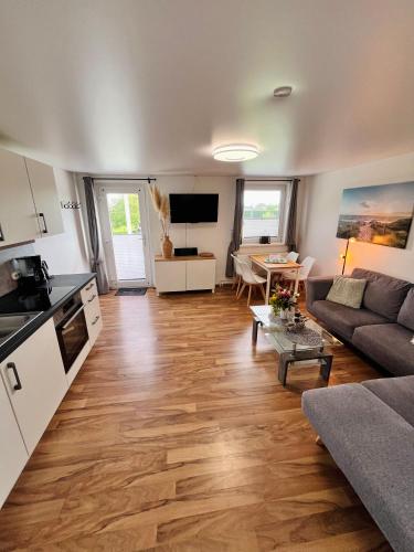 a living room with a couch and a table at Ferienwohnung Nr 4 in Hinrichsdorf
