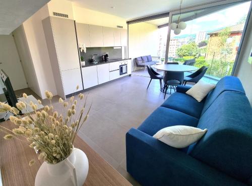 a living room with a blue couch and a table at Kristal Gabri in Lugano