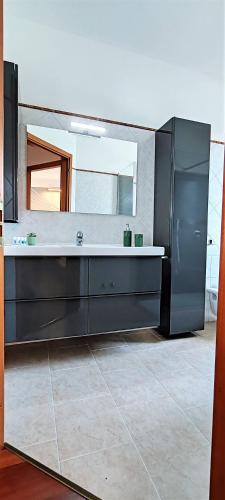 a bathroom with a sink and a mirror at La Casa di Edo in Verona