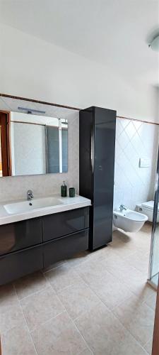 a bathroom with a tub and a sink and a mirror at La Casa di Edo in Verona