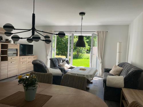 a living room with two couches and a table at Haus Kanalliebe in Nübbel