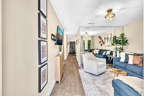 a living room with a blue couch and a table at Estelo's Place - Modern townhouse with King bed, only 5 min from the Airport! in Miami