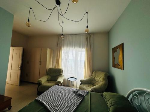 a living room with a couch and chairs and a window at Claude Monet beach hotel in Ureki