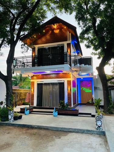 a house with a balcony on the side of it at Neems paradise in Point Pedro