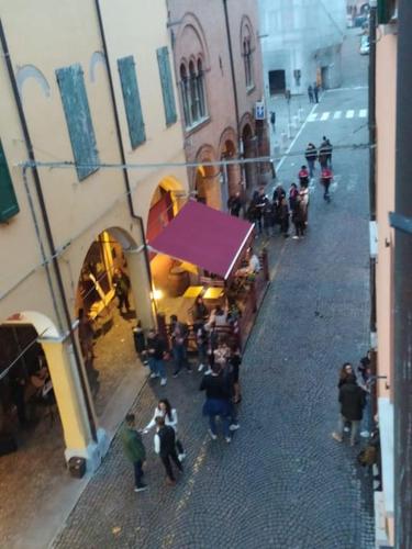 a group of people standing outside of a building at Appartamento Le Palmine in Cento