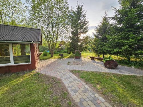 a garden with a bench and a picnic table at Atpūtas vieta Buki in Ventspils