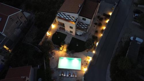 an overhead view of a pool at night at Laura Apartments in Brodarica
