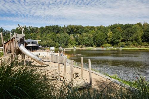 a water park with a slide on the beach at Hillview Hotel Grandvoir in Neufchâteau