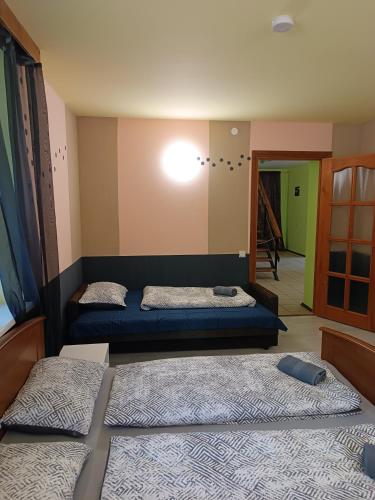 a bedroom with two beds and a light on the wall at Atpūtas vieta Buki in Ventspils