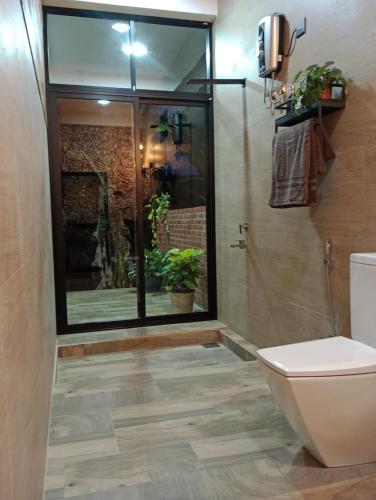 a bathroom with a toilet and a glass shower at Lush In Ella in Ella