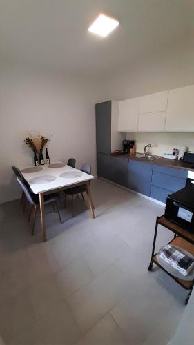 a room with a table and a kitchen with a table and chairs at Barlang utca Villa in Cserszegtomaj