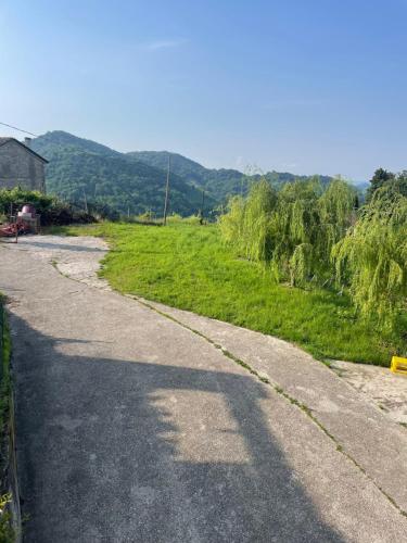 an empty road in a field with mountains in the background at Silvia Miotto's Guesthouse in Guia