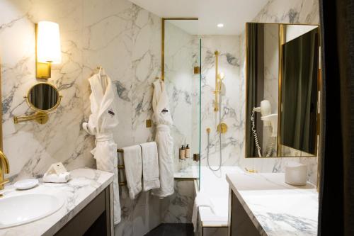 a bathroom with two sinks and a shower at Hôtel Le Relais Saint-Germain in Paris