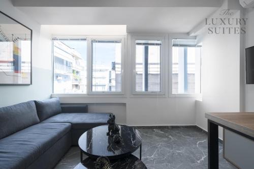 a living room with a couch and a table at Adelle Apartments, The Luxury Suites in Thessaloniki