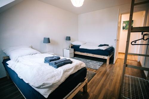 a bedroom with two beds with towels on them at City Apartment Singen in Singen