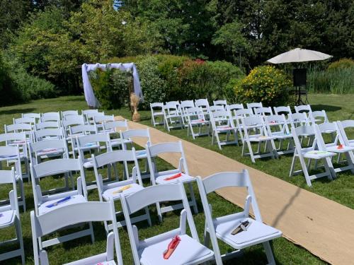 a row of white chairs for a wedding ceremony at Mas Loisonville - Demeure d'exception & Spa en Drôme Provençale in Grillon