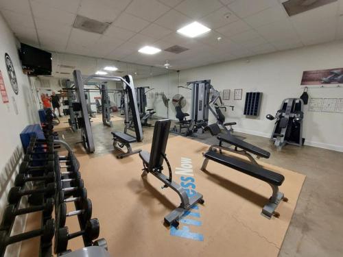 a gym with rows of tread machines in a room at Long Island Village Texas in Port Isabel