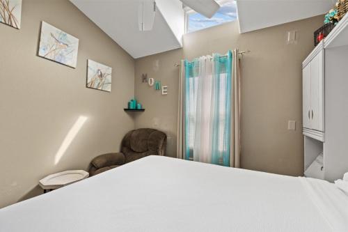 a room with a bed and a shower at Long Island Village Texas in Port Isabel