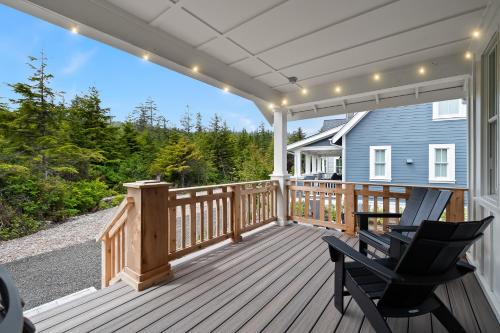 a wooden deck with two chairs on a house at WoodSea Owl by Seabrook Hospitality in Pacific Beach